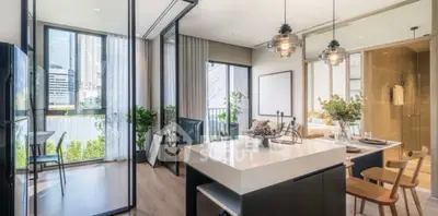Modern open-plan kitchen and living area with stylish decor and city view.