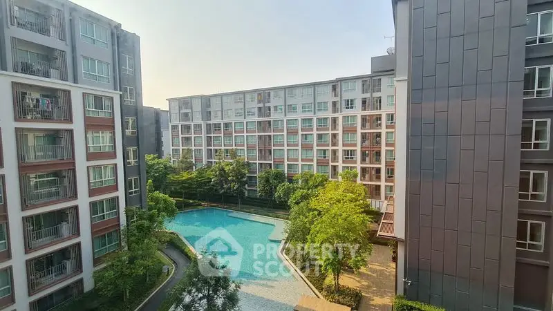 Modern apartment complex with pool and lush greenery view