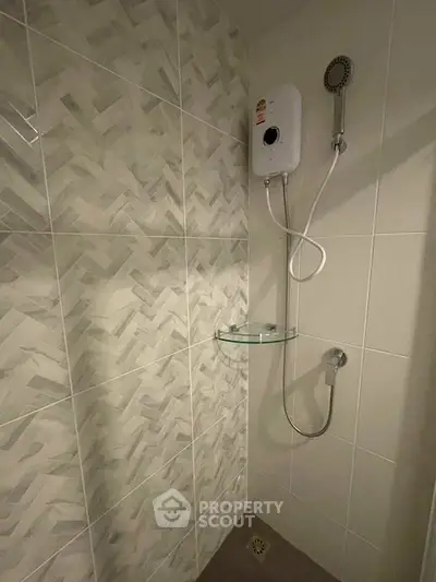 Modern bathroom with stylish tile design and efficient shower system.