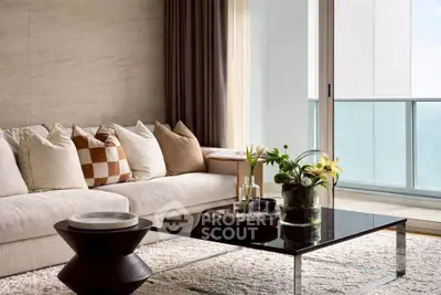 Luxurious living room with plush sofa and modern decor, featuring a stunning balcony view.