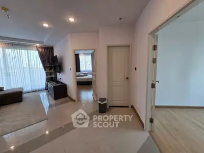 Spacious apartment interior with living room and bedroom view, featuring modern design and natural light.