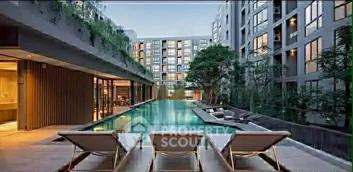 Luxurious apartment complex with stunning pool and modern architecture.