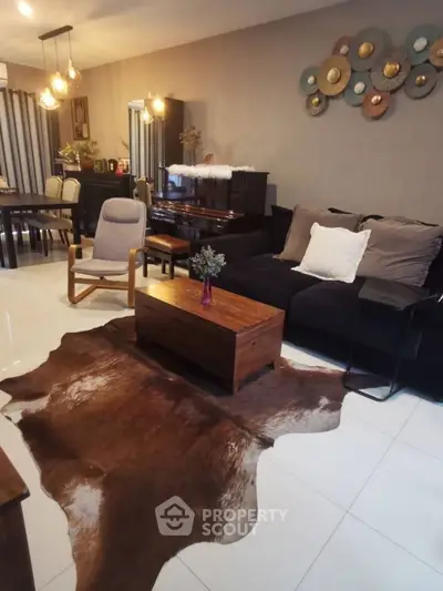 Stylish living room with modern decor and elegant furniture, featuring a unique wall art and cozy ambiance.