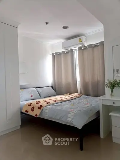 Cozy bedroom with modern decor and natural light, featuring a comfortable bed and stylish furnishings.