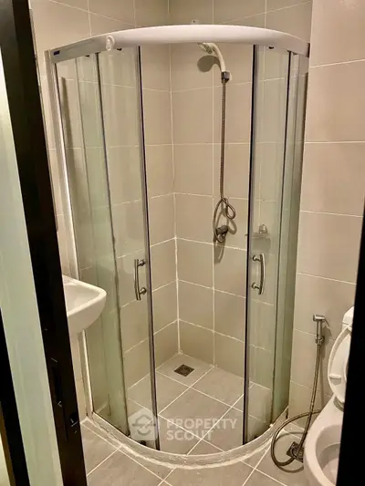 Modern bathroom with glass shower enclosure and sleek tile design