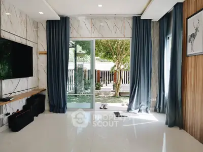 Modern living room with large windows and elegant decor