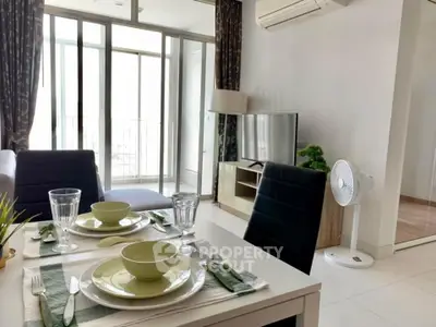 Modern living room with dining area and balcony access in a stylish apartment.