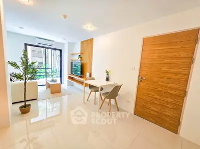Modern living room with sleek design and natural light, featuring a cozy seating area and stylish decor.