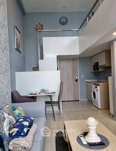 Modern duplex living room with stylish decor and compact kitchen area