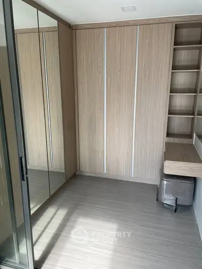 Modern bedroom with mirrored wardrobe and built-in desk