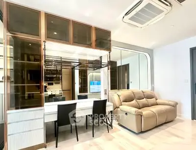 Modern living room with stylish furniture and elegant decor, featuring a cozy sofa and sleek dining area.