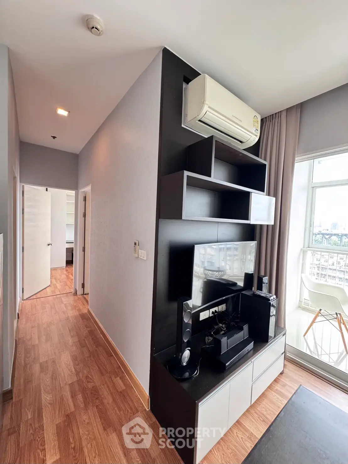 Modern living room with sleek entertainment center and large window view