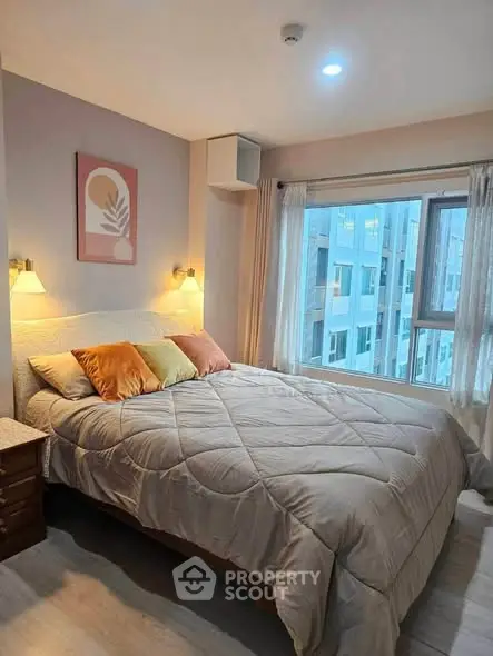 Cozy bedroom with large window and modern decor in urban apartment
