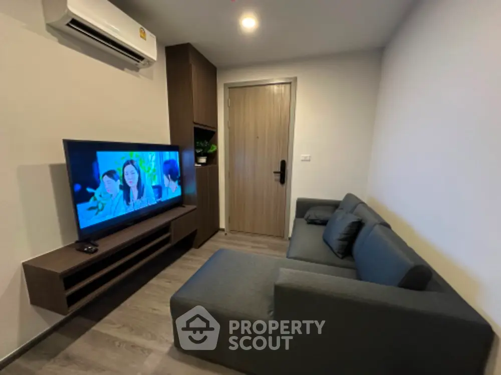 Modern living room with sleek furniture and wall-mounted TV, perfect for cozy relaxation.