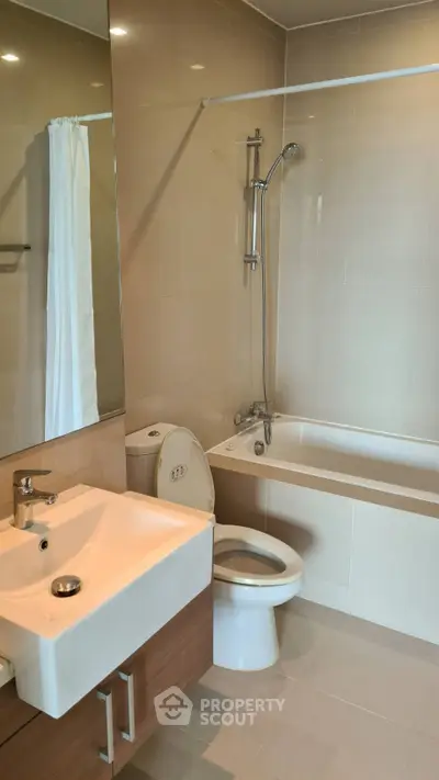 Modern bathroom with sleek fixtures and bathtub in a contemporary apartment.