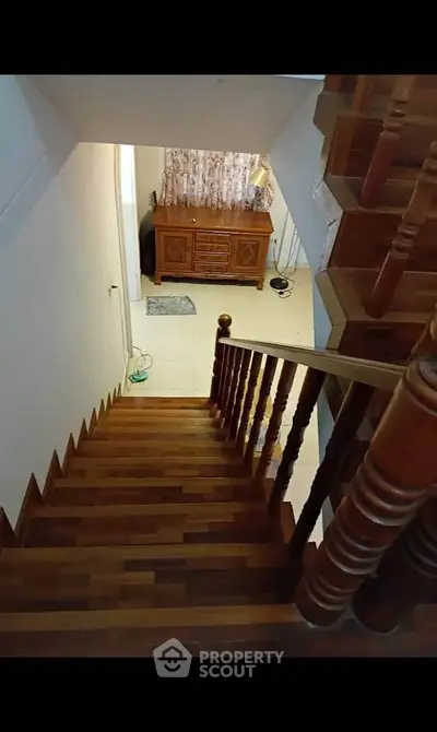 Charming wooden staircase leading to a cozy interior space with elegant decor.