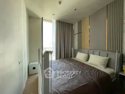 Cozy modern bedroom with large window and elegant curtains