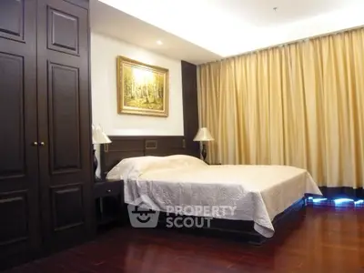 Luxurious bedroom with elegant wooden furnishings and ambient lighting