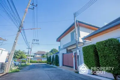 Modern residential building with lush greenery and clear blue sky