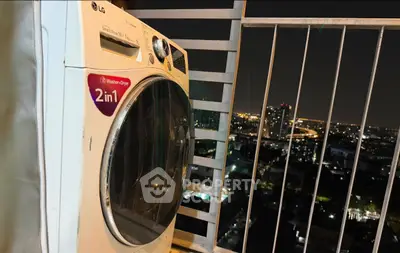 High-rise balcony with city night view and washing machine, perfect for urban living.