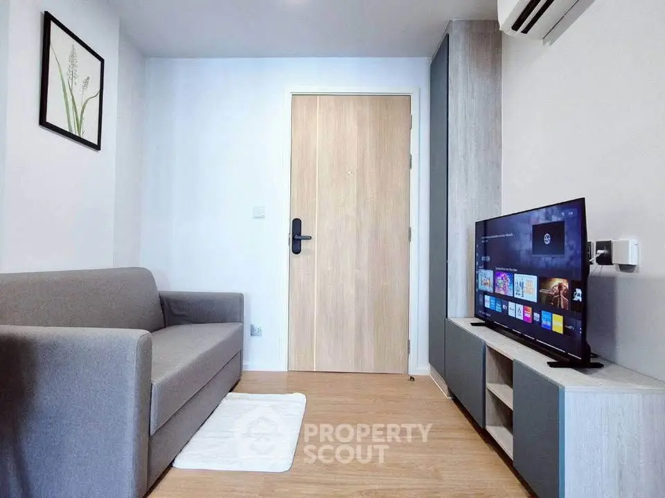 Modern living room with sleek furniture and smart TV, perfect for cozy urban living.