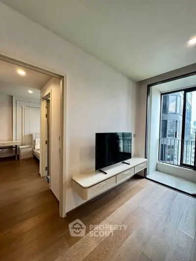 Modern living room with TV and balcony view in a stylish apartment