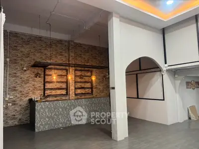 Modern industrial-style interior with exposed brick and stylish lighting, perfect for a trendy cafe or loft space.