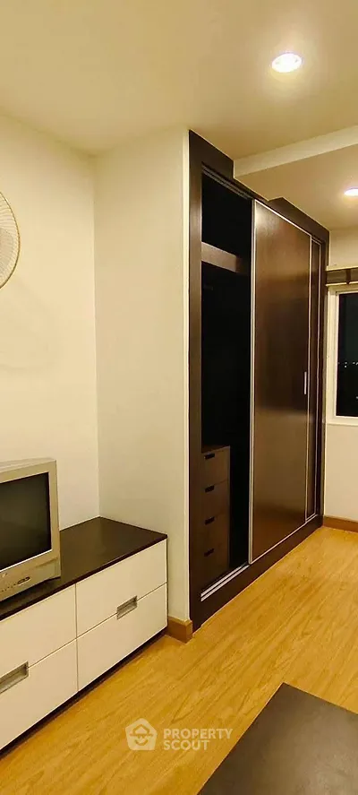 Modern bedroom with built-in wardrobe and sleek TV stand