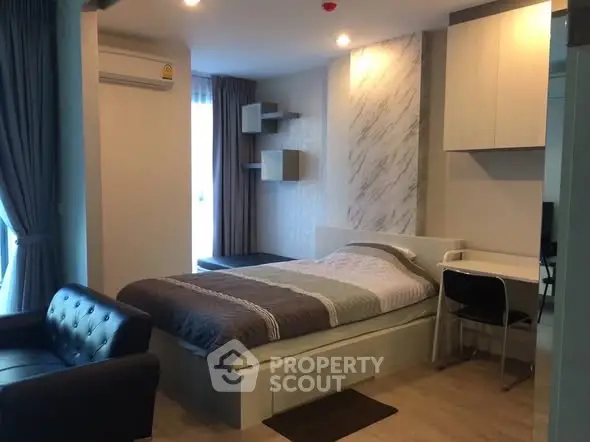 Modern studio apartment with cozy bed and stylish decor