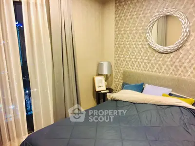 Cozy bedroom with modern decor and city view, featuring stylish bedding and elegant lighting.