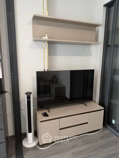 Modern living room with sleek TV setup and stylish shelving