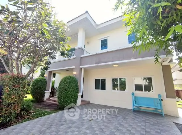 Charming two-story house with lush garden and spacious driveway