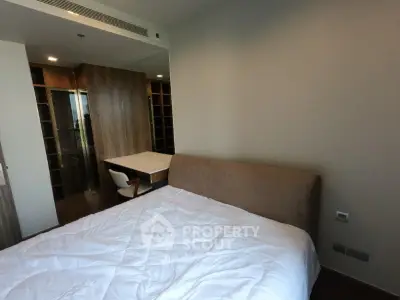 Modern bedroom with cozy bed and built-in wardrobe, perfect for relaxation and comfort.