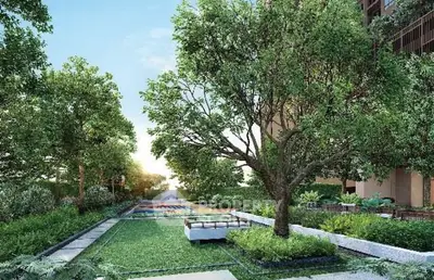 Lush green garden with seating area in modern residential complex