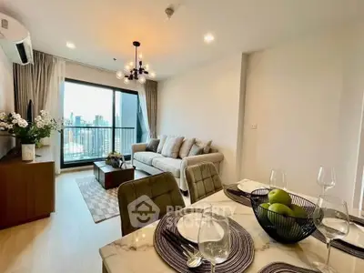 Modern living room with city view, elegant decor, and dining area in a high-rise apartment.