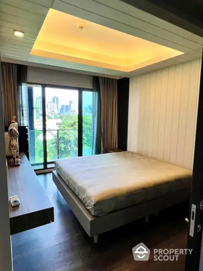 Modern bedroom with city view and stylish decor, featuring large windows and cozy ambiance.