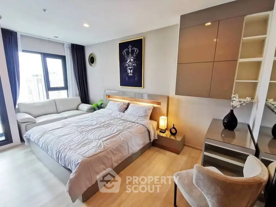 Luxurious modern bedroom with elegant decor and large windows offering natural light.