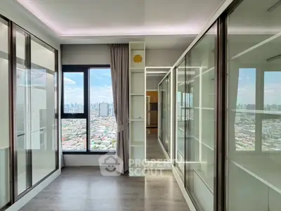 Spacious modern apartment with panoramic city view and sleek glass wardrobes.