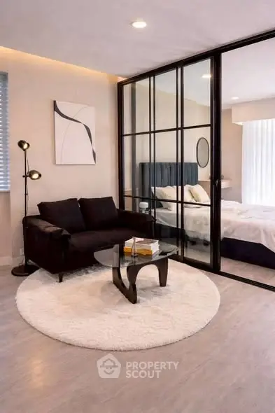 Modern living room with glass partition and cozy bedroom view