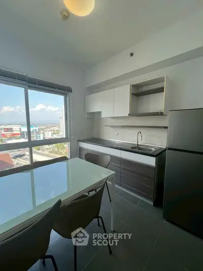 Modern kitchen with dining area and city view from large window