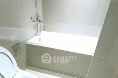 Modern bathroom with sleek bathtub and tiled walls