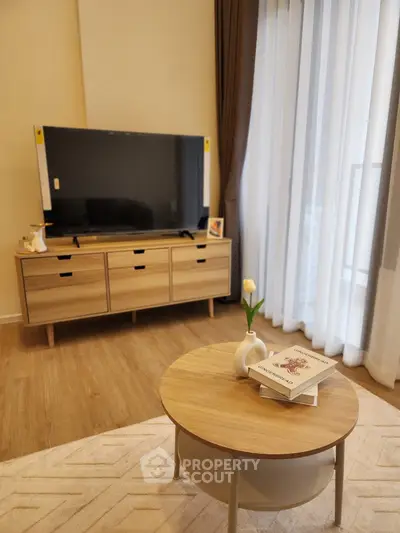 Modern living room with stylish furniture and large TV, perfect for relaxation and entertainment.