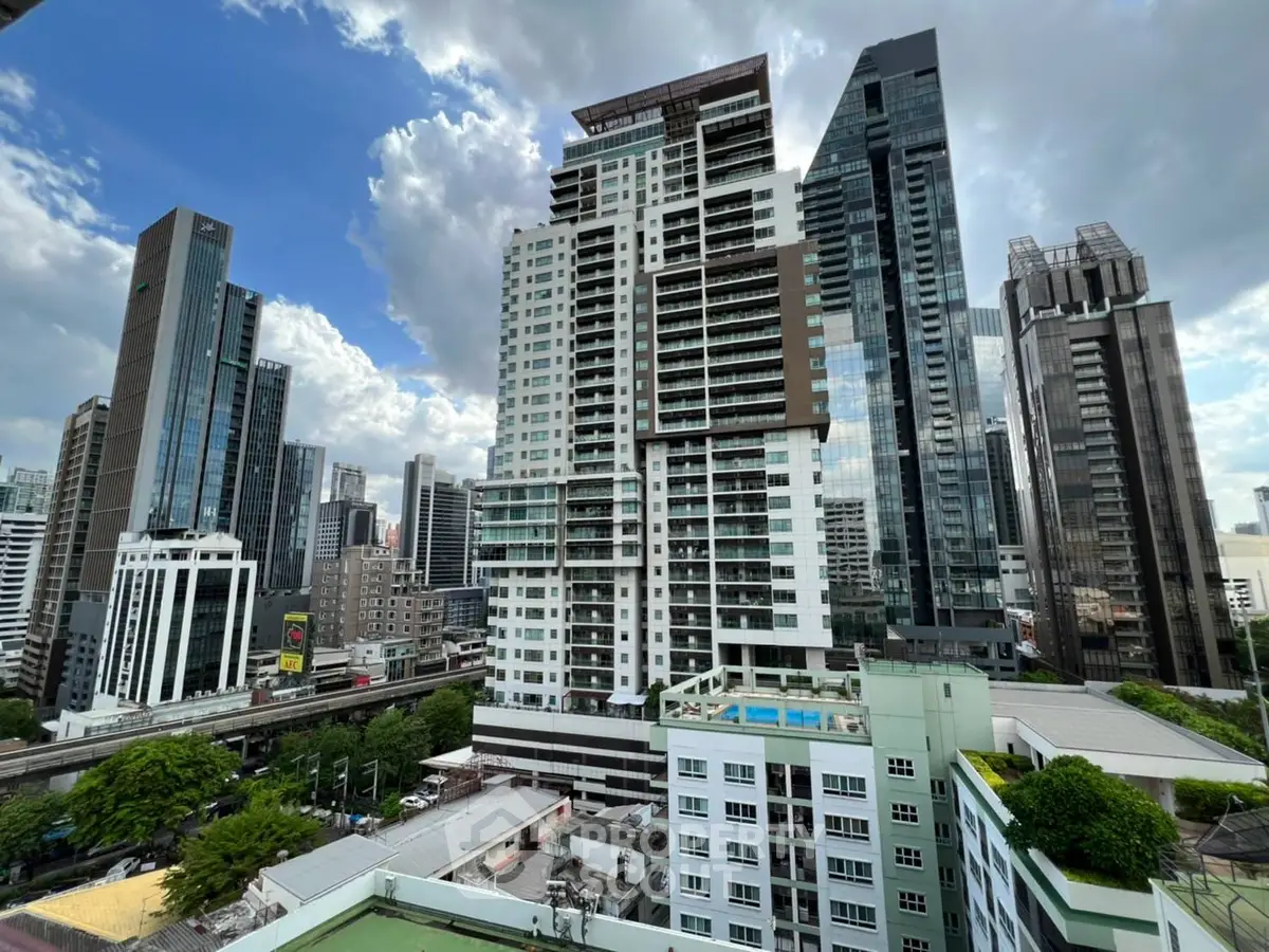 Stunning cityscape view of modern high-rise buildings under a dramatic sky, showcasing urban living at its finest.
