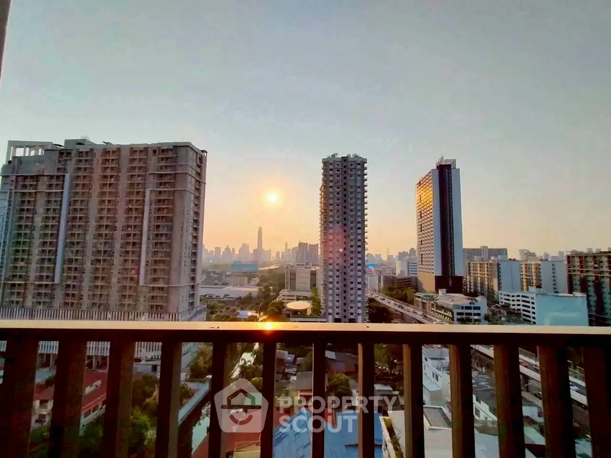 Stunning cityscape view from a high-rise balcony at sunset, showcasing urban skyline and serene ambiance.