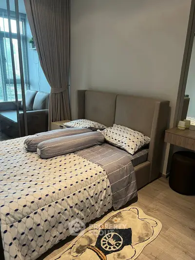 Cozy bedroom with modern decor and large window for natural light