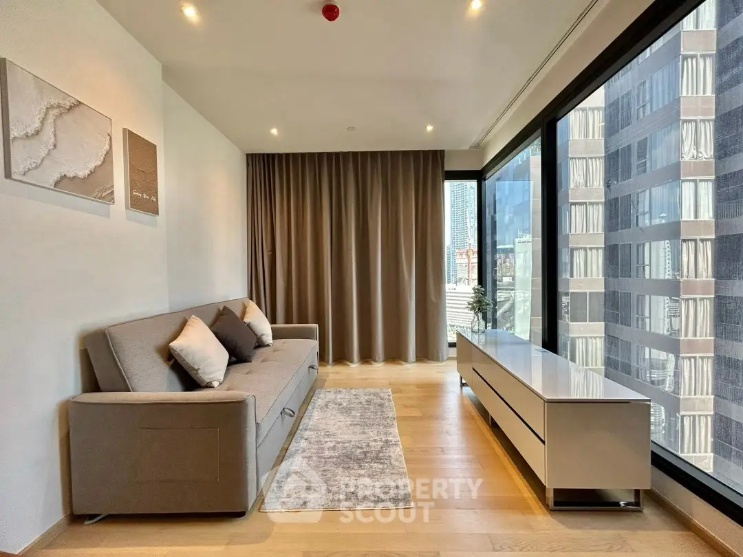 Modern living room with floor-to-ceiling windows and city view, featuring a sleek sofa and minimalist decor.