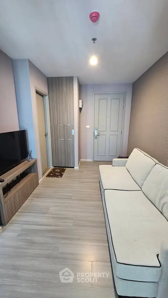 Modern living room with sleek design and cozy sofa in a stylish apartment.