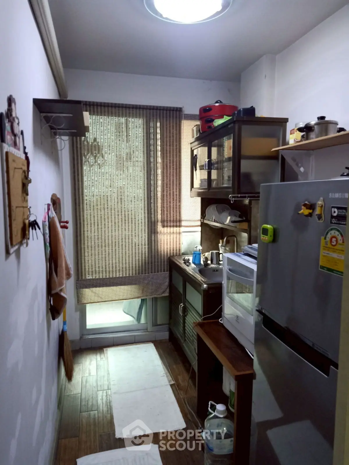 Compact kitchen with modern appliances and natural light, ideal for efficient cooking.