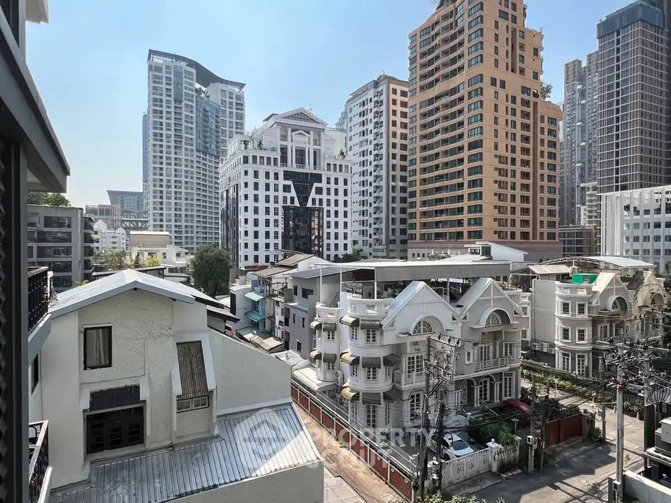 Stunning urban skyline view with modern high-rise buildings and charming residential houses.
