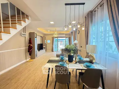 Elegant open-plan living and dining area with modern decor and ample natural light.